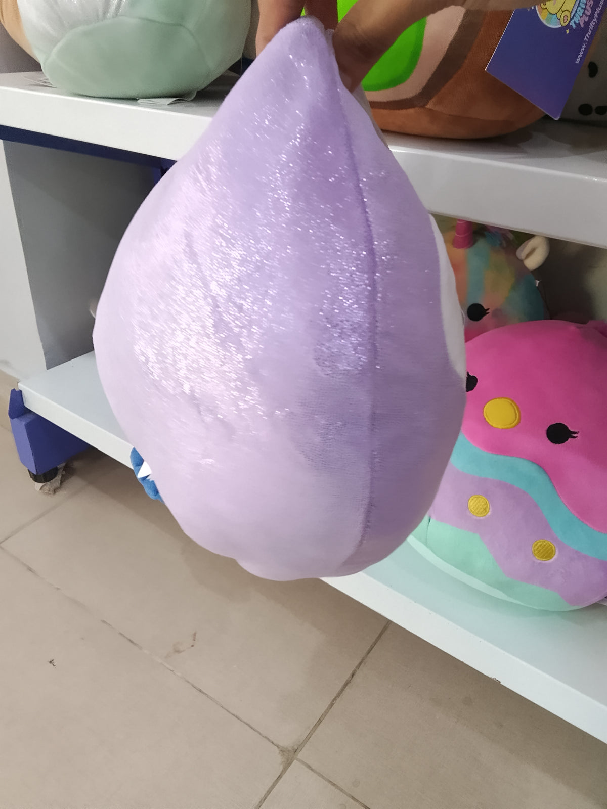 Squishmallows plush toy of Elle the Penguin in purple.