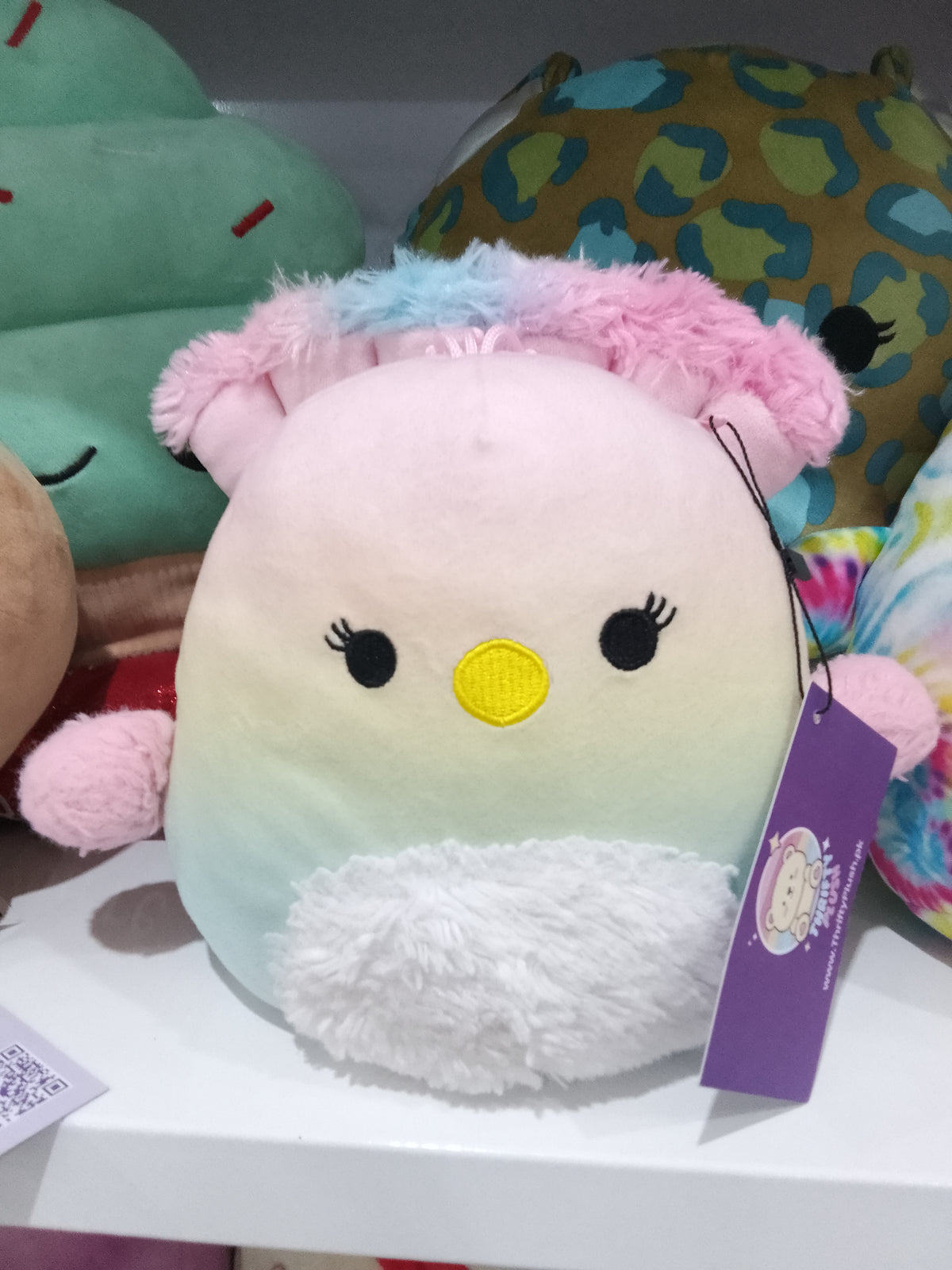 Squishmallows Briannika the Peacock plush toy, pastel ombre design and fluffy wings.