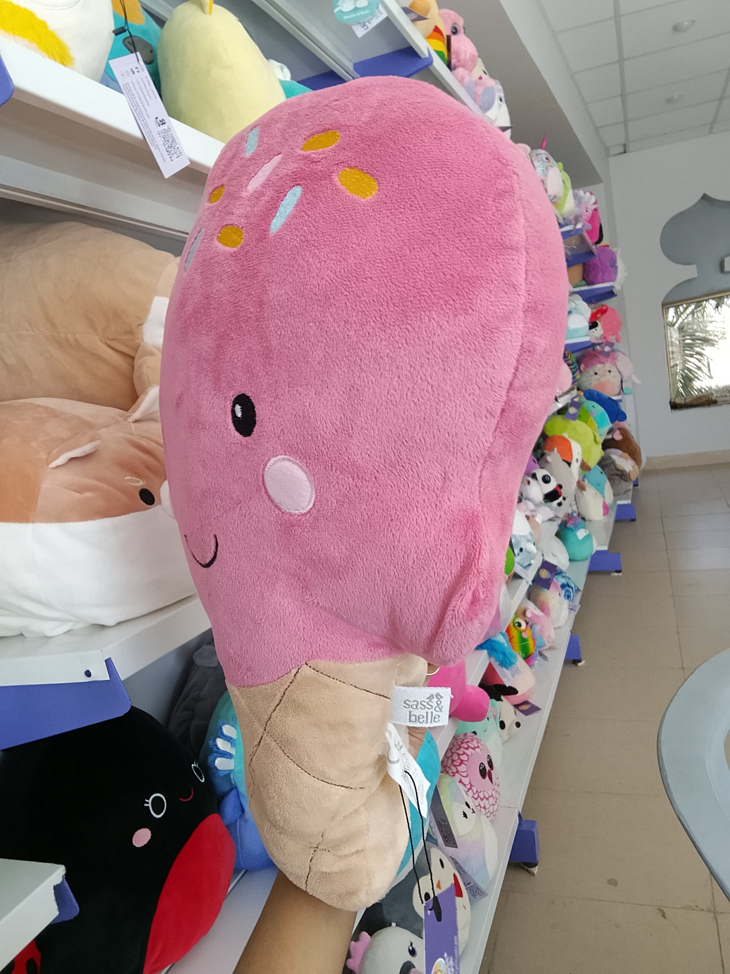 Squishmallows pink ice cream cone plush toy.