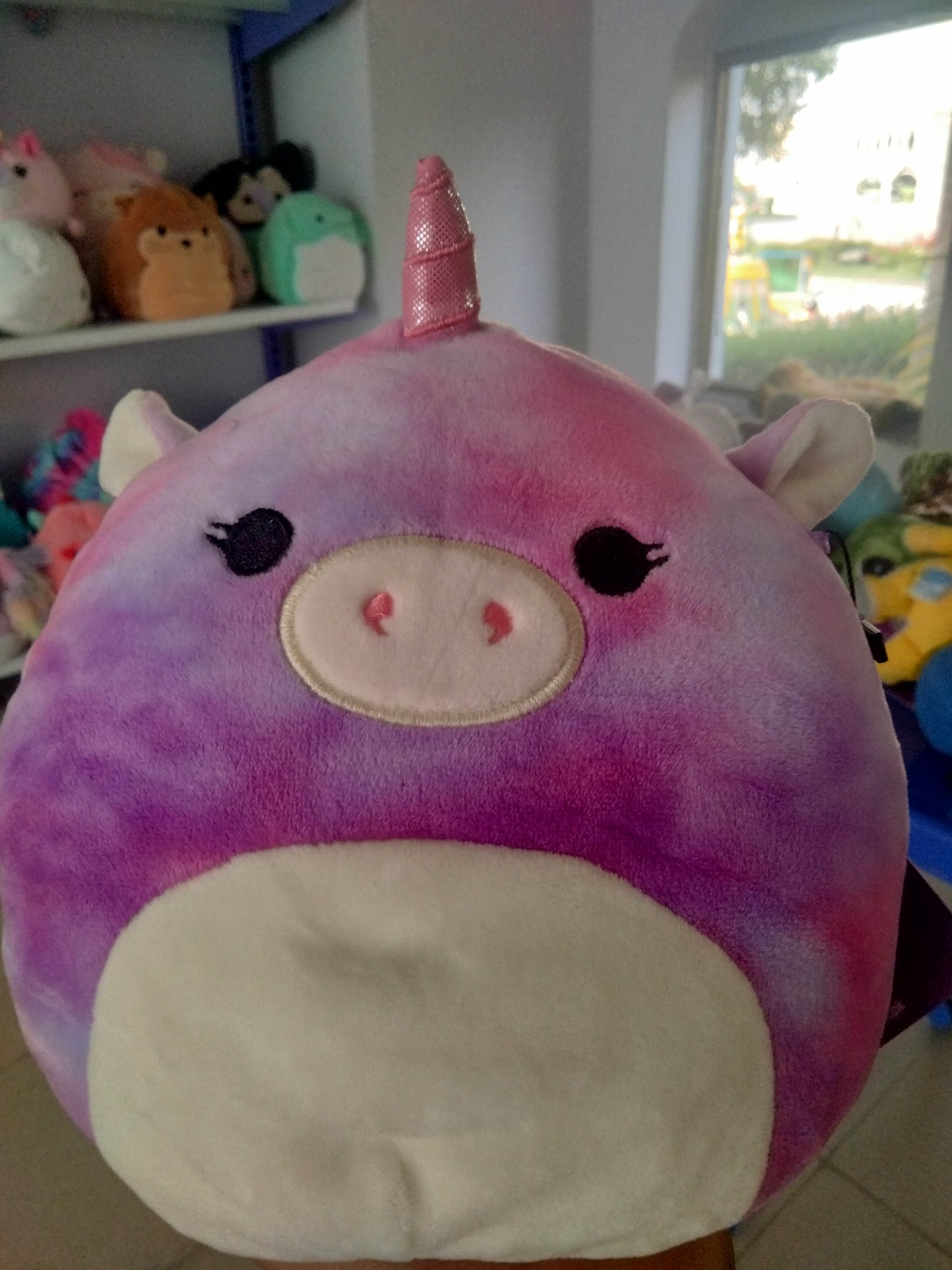 Squishmallows Astrid The Unicorn with Sleepy Eyes plush toy.